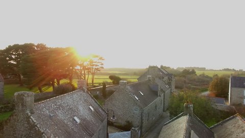 Flying over the village and the chapel of "Saint Colomban" at sunset, located in Carnac, Morbihan, Bretagne, France. Carnac is well-known for its famous rows of standing stones.