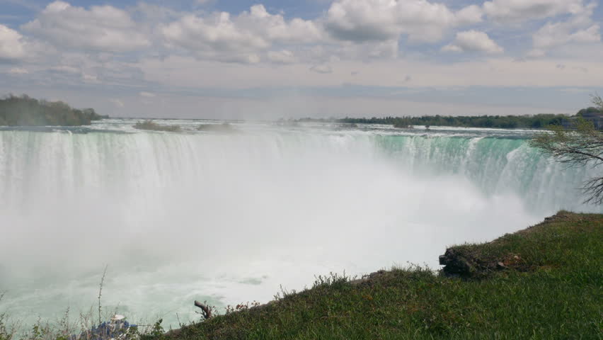 Clouds of Mist rise as the waters of the Niagara River violently stirred by the mighty drop from the Horseshoe Falls. 