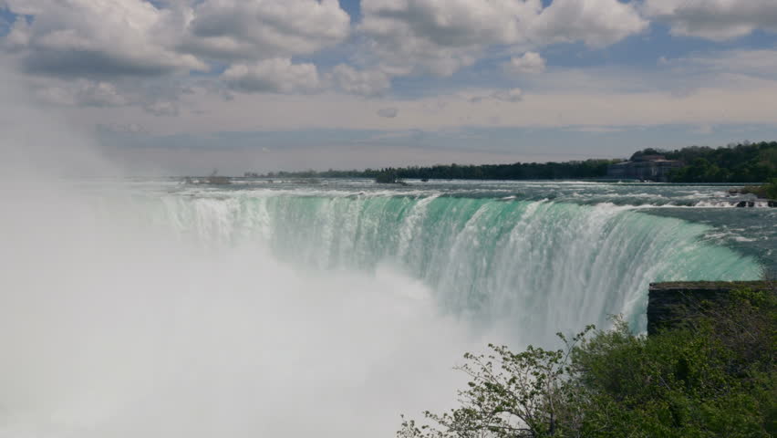 Mist rises as the waters of the Niagara River violently stirred by the mighty drop from the Horseshoe Falls. 
