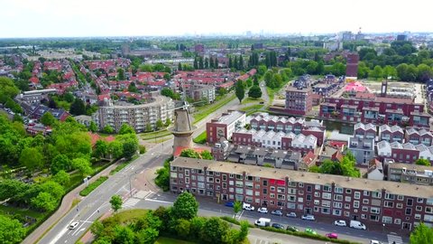 Drone shot, typical Dutch city, village near Amsterdam, windmill in Holland