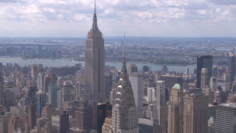 NEW YORK USA - SEPTEMBER 4,2016,  AERIAL CLOSE UP ESTABLISHING SHOT: Flying above Manhattan, past the Chrysler building, towards Empire state. Aerial view of NY skyscrapers with Hudson river.

