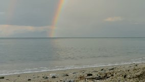 Seascape with rainbow and sand beach after rain in Greece, Platamon Olympus region