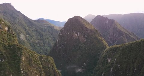 Aguas Calientes Peru Aerial v5 Flying high above town with mountain and Machu Picchu views