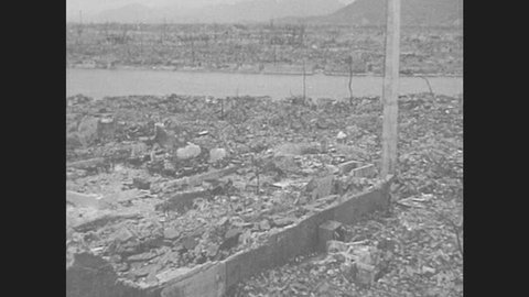 JAPAN 1940s: Hiroshima: Ruins of factory, only smokestack and foundation remain. Concrete skeleton of building standing amid rubble. Buildings standing amid rubble.