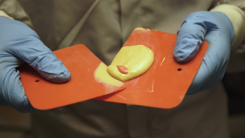 The mixing of auto primer on the spatula. 4K