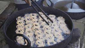 An indian street side food stall is making a famous Indian sweet