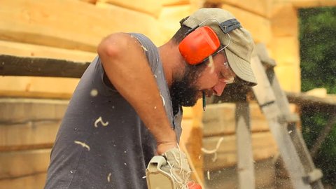 worker chainsaw sawdust