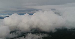 Beautiful cinematic aerial view of huge white clouds .Flying in and out of clouds .Flying in a plane through the fluffy, snow-white clouds.Heaven video background concept.