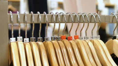 Clothes on Hangers In Clothing Shop. Shopping Concept. 4K Closeup. 