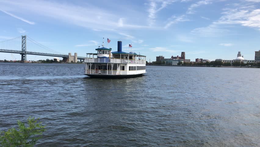 RiverLink ferry traveling north on the Delaware River towards the Ben Franklin Bridge on its way to Camden NJ from Philadelphia