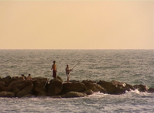Fisherman fishing at sunset