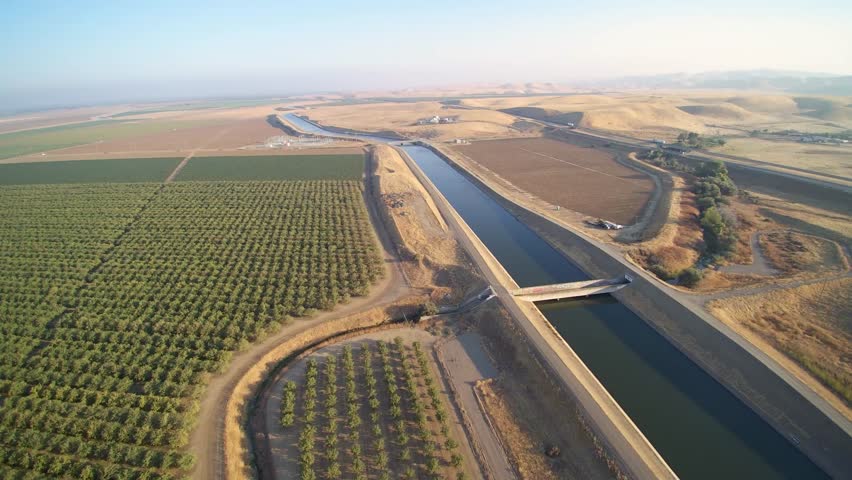 Aerial view of California farms over the California aqueduct. Royalty-Free Stock Footage #30374884
