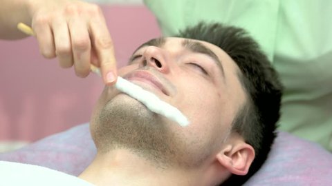 Face cryomassage, caucasian man. Skin cryotherapy close up. Liquid nitrogen use in medicine.