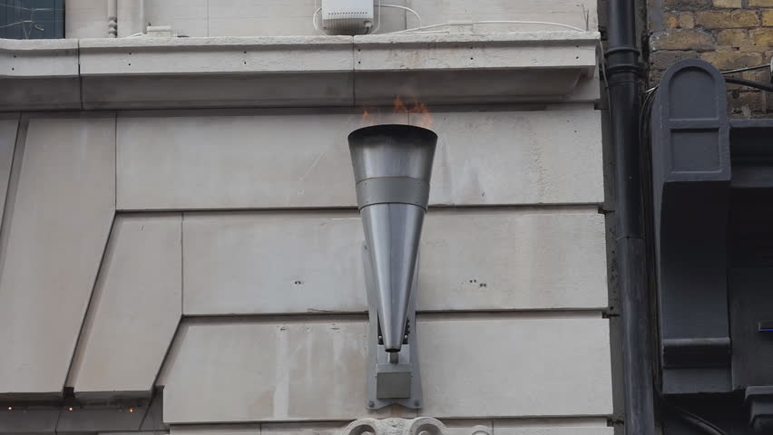 A torch with fire on the wall.