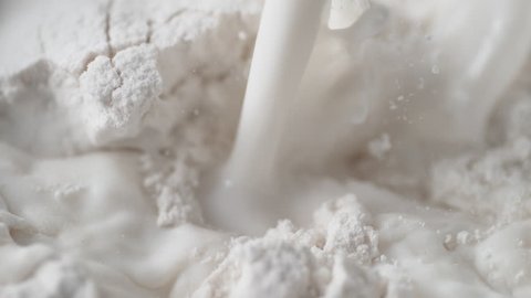 Pouring milk into flour. Shot with high speed camera, phantom flex 4K. Slow Motion.