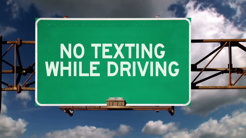 No texting while driving road sign.
