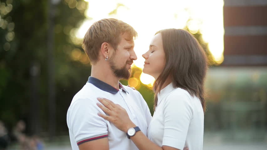 Outdoors Portrait of Young Couple in Love Kissing and Hugging During Sunset in the City.