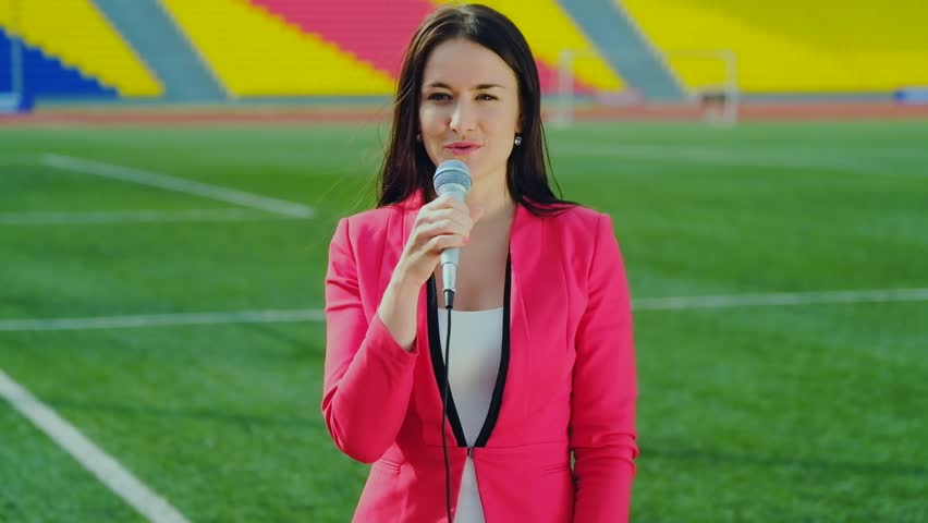 The journalist is reporting from the stadium for television