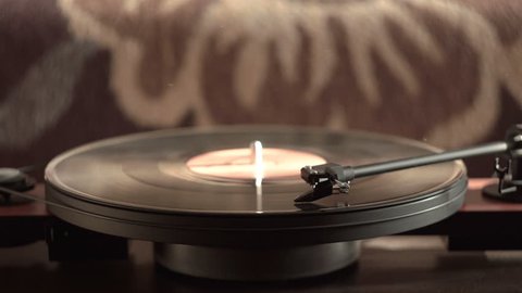 Vintage record player with vinyl disc, close-up. warm sunlight