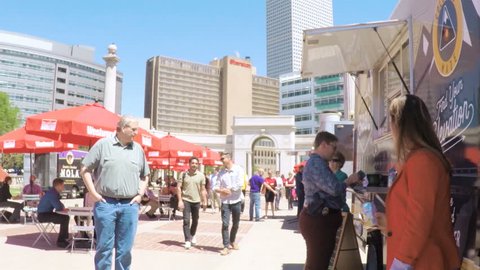 Denver, Colorado, USA-June 15, 2017.  POV point of view - Slow motion. Lunch time gathering of gourmet food trucks at the Civic Center Park.