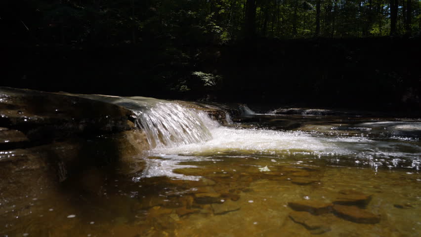 Small Waterfall in Cuyahoga Valley Creek Flowing quickly as camera pans