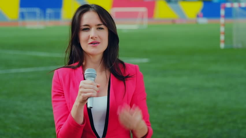 Young girl TV reporter is broadcasting from stadium
