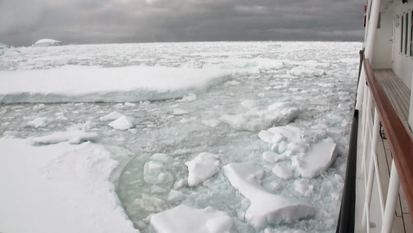 Ice movement and snow iceberg and glacier view from ship in ocean of Antarctica. Amazing unique beautiful wilderness nature and landscape of white mountains. Extreme tourism cold desert north pole.