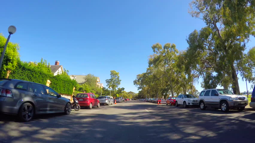 Adelaide City, South Australia, vehicle POV driving along East Terrace past the parklands and South East Corner residential area.
