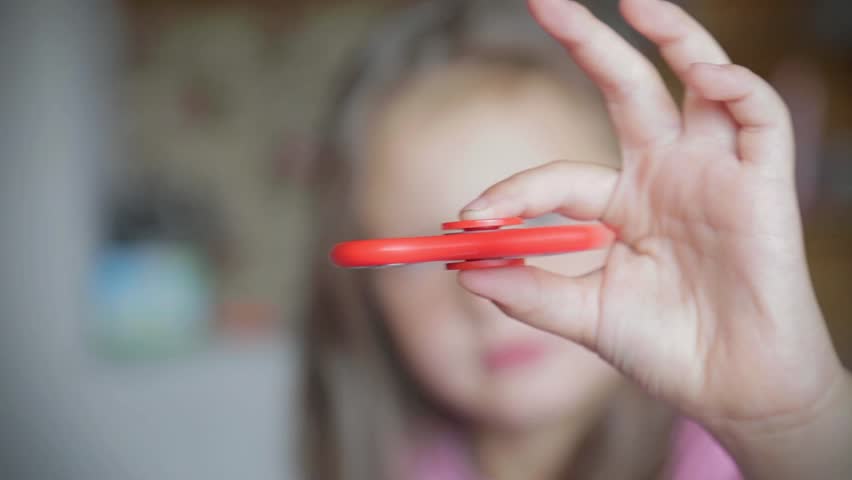 Little girl playing with spinner.
