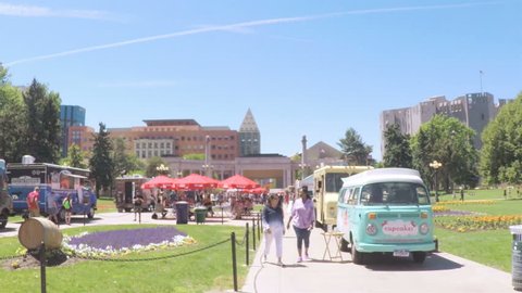 Denver, Colorado, USA-June 15, 2017.  POV point of view - Slow motion. Lunch time gathering of gourmet food trucks at the Civic Center Park.