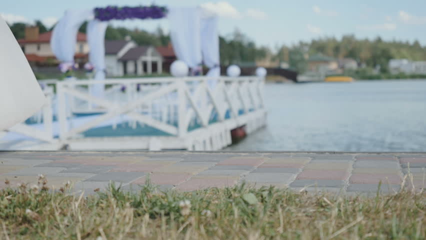 The legs of bride and groom are going on river background