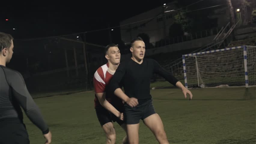 Workout of rugby professional team outdoor at night, football training