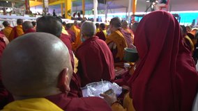 A buddhist monk is listening to radio