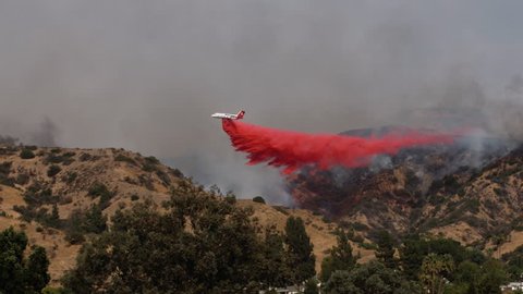 Airplane Drops Fire Retardant on Wildfire