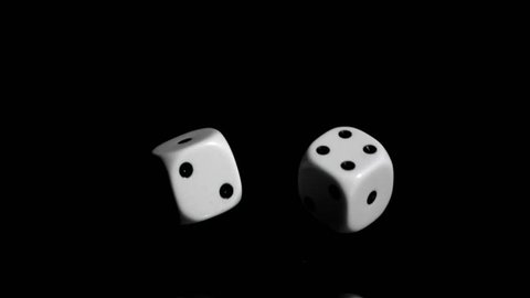 Two white dices in super slow motion rebonding against a black background