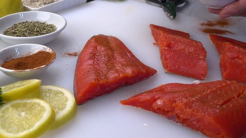 Wild salmon prepared with fresh herbs, spices, slider shot. 4K UHD 3840x2160
