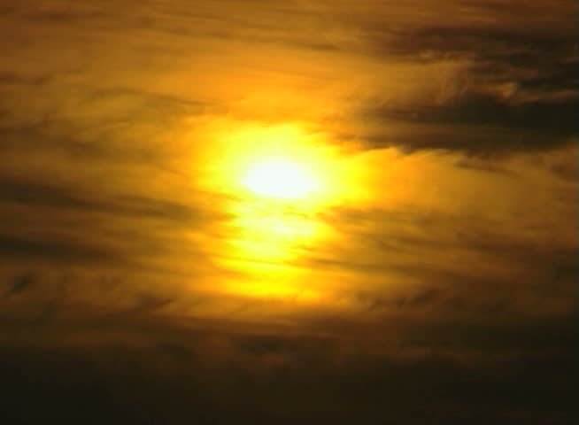 Sunset clouds time-lapse. Sun close up.