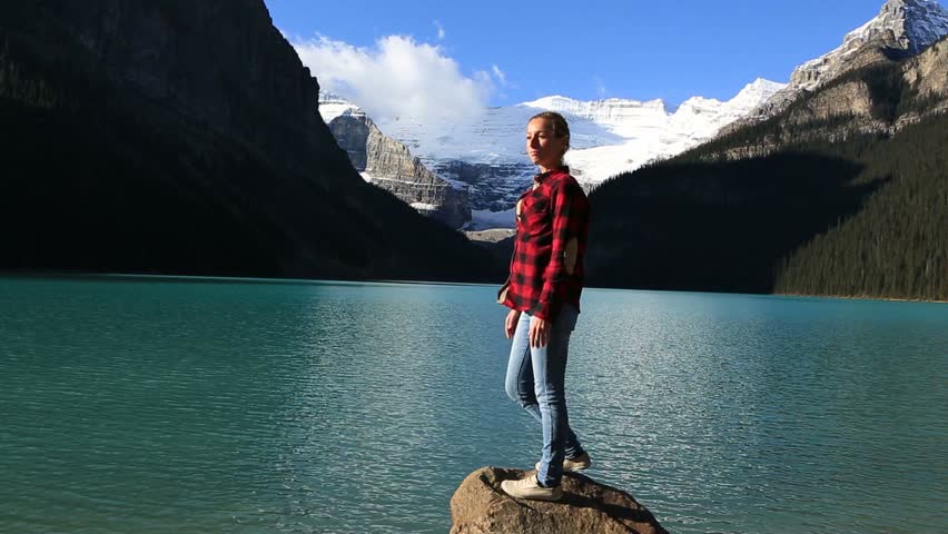 Woman arms outstretched by beautiful lake
Shot at lake Louise, Alberta, Canada
People travel relaxation concept