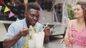 leisure and people concept - happy friends with drinks eating wok at food truck - Powered by Shutterstock - Get 15% off with code: PIKWIZARD15