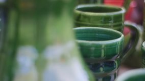 Hand Made Ceramics, Potter's Workshop, Enameled Beautiful Vessels. All Dishes Are Made by Hand. Green Clay Mugs Are Covered With Enamel Inside. High Green Jugs With a Small Elegant Handles. Video in