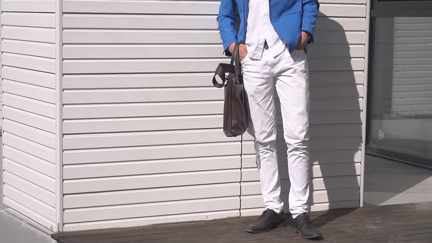 Portrait of an attractive young businessman on background of modern building.