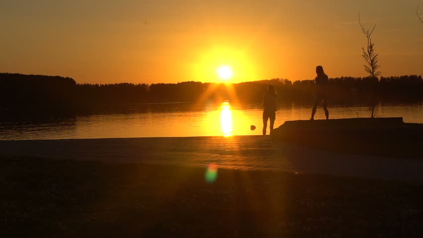 two two young women on the evening lake
