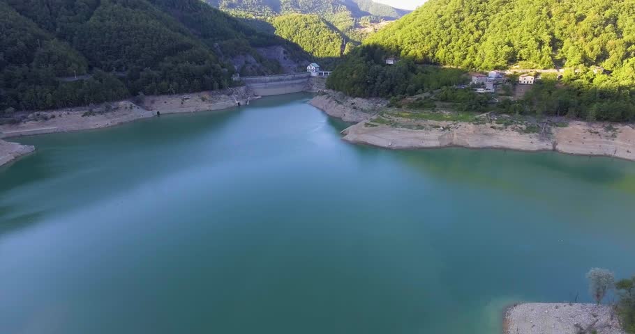 Aerial, beautiful lake with a dam barrier among the hills