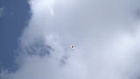 Red Su-31 among clouds shows a figure of aerobatics called Tailside