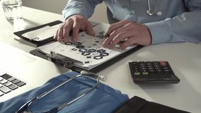 Healthcare costs and fees concept.Hand of smart doctor used a calculator for medical costs in modern hospital and drinking a glass of water in 4k(UHD) - Powered by Shutterstock - Get 15% off with code: PIKWIZARD15