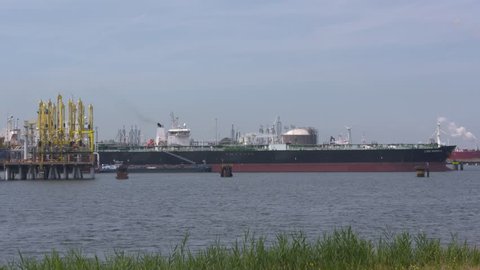 ROTTERDAM SEAPORT - JULY 2017: crude oil tanker Lyric Magnolia bunkering and unloads at Europoort (gate to Europe) industrial area with petrochemical refineries and storage tanks