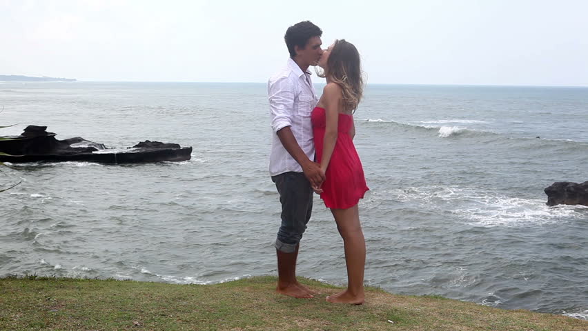 Happy lovers kissing and hugging at bali coast