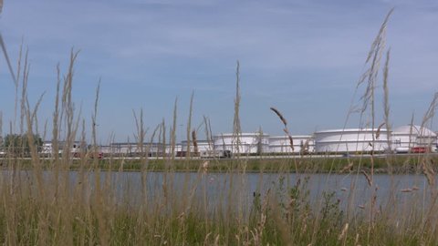 EUROPOORT, ROTTERDAM SEAPORT: oil storage tanks alongside A15 highway and Hartel canal (hartelkanaal)