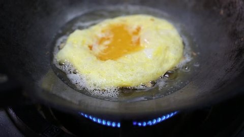 Omelet in hot pan with oil 