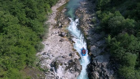 A rafting boat goes down the rapids on a river...